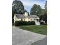 Street view of a cozy home featuring a driveway and lush green landscaping at 5809 Iris Lake Ct, Raleigh, NC 27604