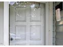 Close-up of a white front door with glass panels and an ornate exterior light fixture at 5810 Shady Grove Cir, Raleigh, NC 27609