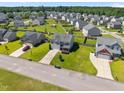 Aerial view of a neighborhood featuring single-Gathering homes with green lawns and mature trees at 737 Botanical Ct, Bunnlevel, NC 28323