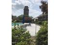 Exterior shot of a large community pool with lounge chairs and tables with umbrellas at 807 W Trinity Ave # 209, Durham, NC 27701
