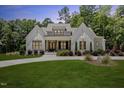 Charming white brick home with a well-manicured lawn, beautiful landscaping, and a welcoming entrance at 8420 Bells Lake Rd, Apex, NC 27539