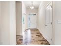 Bright foyer with wood-look floors and white trim throughout the hallway at 88 Longo Ln, Benson, NC 27504