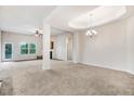 Spacious living room with carpeting and a tray ceiling with chandelier at 88 Longo Ln, Benson, NC 27504