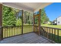 A relaxing screened-in porch offering views of the lush backyard and surrounding greenery at 933 Weatherby Ln, Creedmoor, NC 27522