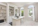 Bright office featuring custom built-ins, arched windows, and neutral carpet at 101 Lochmere Forest Dr, Cary, NC 27518