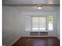 Bright living room with hardwood floors, a large bay window seat, and classic white trim at 103 Sara Dr, Nashville, NC 27856