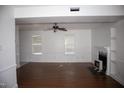 Bright living room featuring hardwood floors, a ceiling fan, and a fireplace at 103 Sara Dr, Nashville, NC 27856