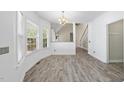 Inviting dining area with large windows and a view into a living space with a staircase at 107 Roan Dr, Garner, NC 27529