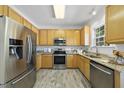 Updated kitchen boasts stainless steel appliances, granite countertops, and stylish wood-look flooring at 107 Roan Dr, Garner, NC 27529