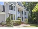 Close-up shot of a two-story home featuring large windows, trimmed hedges, and a well-manicured lawn at 110 Duckwood Ln, Cary, NC 27518