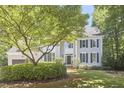 Traditional home with lush landscaping, and a charming front yard tree at 110 Duckwood Ln, Cary, NC 27518