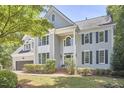 Beautiful home with a manicured lawn, trimmed hedges, black shutters, and a two-car garage at 110 Duckwood Ln, Cary, NC 27518
