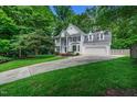 Well-maintained home featuring a lush green lawn and a long private driveway at 12 Gatesway Ct, Durham, NC 27707