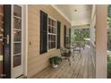 Relax on this cozy covered front porch with views of the green outdoors and a lovely seating area at 126 Captains Ct, Durham, NC 27712