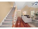 Spacious living room features hardwood floors, vaulted ceilings and an adjacent staircase at 126 Captains Ct, Durham, NC 27712