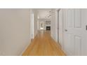 Inviting hallway features hardwood floors and leads to a bright living area with a fireplace, offering a warm welcome at 127 Strike Eagle Dr, Broadway, NC 27505
