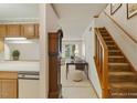 Inviting foyer featuring a staircase, coat closet, and views of the living area at 14 Quintin Pl, Durham, NC 27705