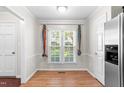 Bright dining area with hardwood floors and a large window at 144 Greenmont Ln, Cary, NC 27511