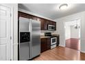 Modern kitchen featuring stainless steel appliances, wood cabinets, and granite countertops at 144 Greenmont Ln, Cary, NC 27511