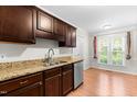 Stylish kitchen with granite countertops, stainless steel appliances, and dark wood cabinets at 144 Greenmont Ln, Cary, NC 27511