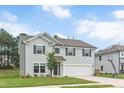 Charming two-story home with gray siding, attached garage, and well-manicured lawn at 1471 Carlton Links Dr, Fuquay Varina, NC 27526