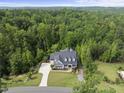 Expansive aerial view of a gorgeous home nestled amongst lush green trees at 175 Stonecrest Way, Pittsboro, NC 27312