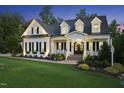Charming two-story home with inviting entrance, manicured lawn, and blooming flowers at 175 Stonecrest Way, Pittsboro, NC 27312