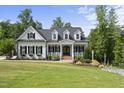 Charming two-story home with black shutters and brick walkway leading to a welcoming porch at 175 Stonecrest Way, Pittsboro, NC 27312
