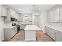 Bright kitchen featuring gray cabinets, white countertops, a spacious island and stainless steel appliances at 1812 Gazania Dr, Fuquay Varina, NC 27526