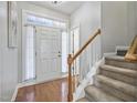 Welcoming foyer with hardwood flooring, staircase, transom window, and bright natural light at 2069 White Pond Ct, Apex, NC 27523