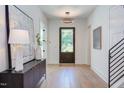 Bright foyer with hardwood floors, a decorative light fixture, and stylish accents at 2114 Cowper Dr, Raleigh, NC 27608