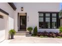 Front entrance with stone steps, and landscaped plantings leading to a modern style front door at 2114 Cowper Dr, Raleigh, NC 27608
