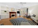 Cozy living room with fireplace, built-in shelves, and French doors to the exterior at 2617 Cottage Cir, Raleigh, NC 27613