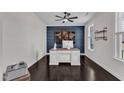 Modern home office with a stylish desk, decorative maps, and a ceiling fan at 326 S Parliament Way, Clayton, NC 27520