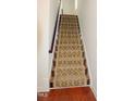 Carpeted staircase leading to the upper level of the house with hardwood flooring at the base at 332 Bridgegate Dr, Cary, NC 27519