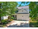 Home featuring a well-manicured lawn, beautiful landscaping, and a two-car garage at 410 Willingham Rd, Morrisville, NC 27560