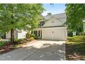 Two-story home with a well-maintained lawn, a two-car garage, and a cozy front porch at 410 Willingham Rd, Morrisville, NC 27560