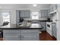 This kitchen boasts gray cabinets, an island, and an eat-in dining area at 4505 Woodlawn Dr, Raleigh, NC 27616