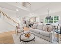 Spacious living room with an open concept design and hardwood floors at 525 Kings Lake Way, Durham, NC 27703