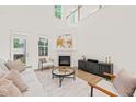 Inviting living room featuring neutral decor, fireplace and abundant natural light at 525 Kings Lake Way, Durham, NC 27703