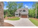 Charming two-story home with gray siding, stone accents, and a well-manicured front yard at 5504 Earle Road, Raleigh, NC 27606