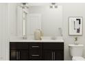 Bright bathroom features double sink vanity with sleek dark cabinets and modern fixtures, offering style and functionality at 5545 Cayden Cove Dr, Wendell, NC 27591