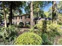 Traditional brick home featuring classic shutters and surrounded by lush greenery at 5617 Partridge Ln, Raleigh, NC 27609