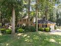 Spacious brick home featuring an attached garage and a lush, green lawn at 5617 Partridge Ln, Raleigh, NC 27609