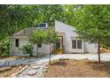 Lovely exterior view of a cozy home surrounded by lush greenery and a gravel walkway at 5709 Russell Rd, Durham, NC 27712