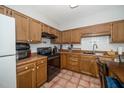 Functional kitchen with wood cabinets, tiled backsplash, and updated appliances for cooking convenience at 6008 River Lake Cir, Raleigh, NC 27604