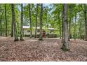 Traditional home showcasing natural landscaping surrounded by lush trees at 623 Totten Pl, Chapel Hill, NC 27514