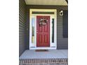 Welcoming front door with wreath and sidelights at 644 Wall Rd, Wendell, NC 27591