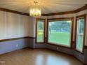 Dining room featuring wood floors, decorative trim and large windows with a view at 759 Wheeler Dr, Angier, NC 27501