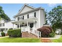 Charming two-story home with white siding, black shutters, front porch, and landscaped yard at 8513 Buscot Ct, Raleigh, NC 27615